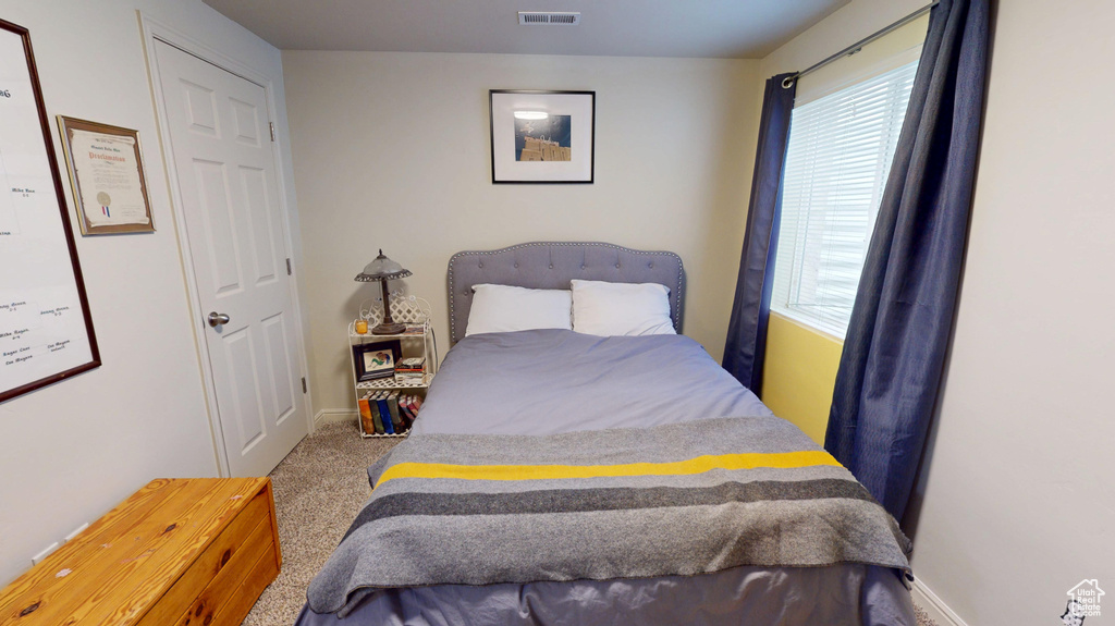 Carpeted bedroom featuring baseboards