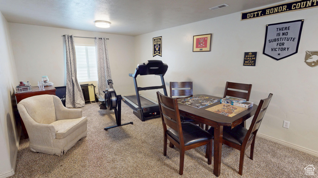 Dining room featuring carpet floors and baseboards