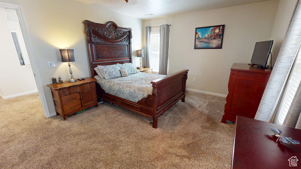 Bedroom featuring light carpet