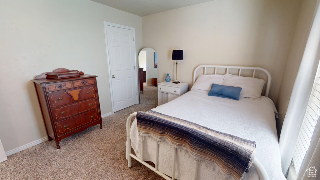 Bedroom featuring carpet flooring and baseboards