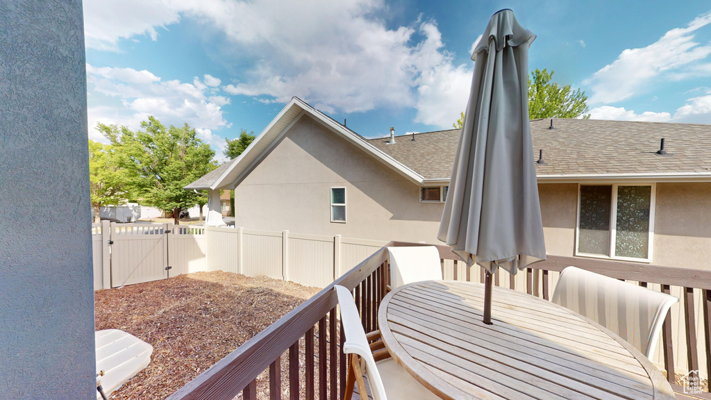 Wooden deck with a gate and outdoor dining space