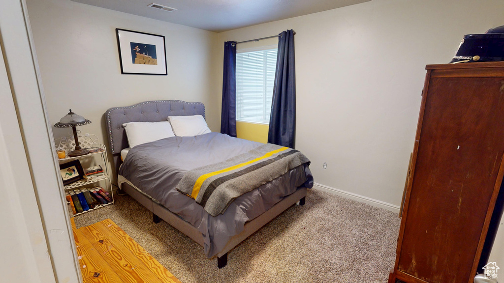Carpeted bedroom with baseboards