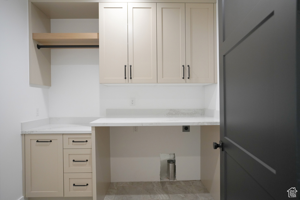 Laundry room with electric dryer hookup and cabinet space
