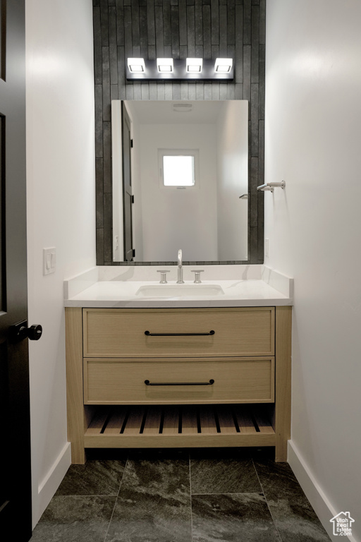 Bathroom featuring vanity and baseboards