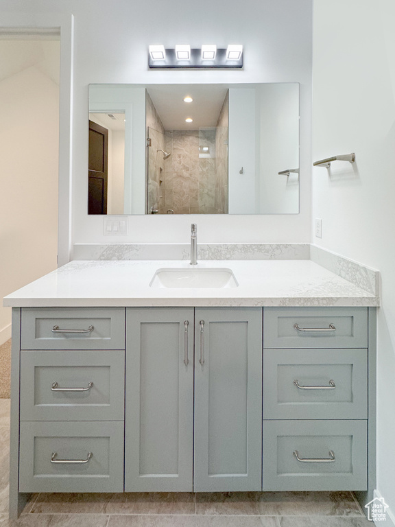 Bathroom featuring vanity and tiled shower