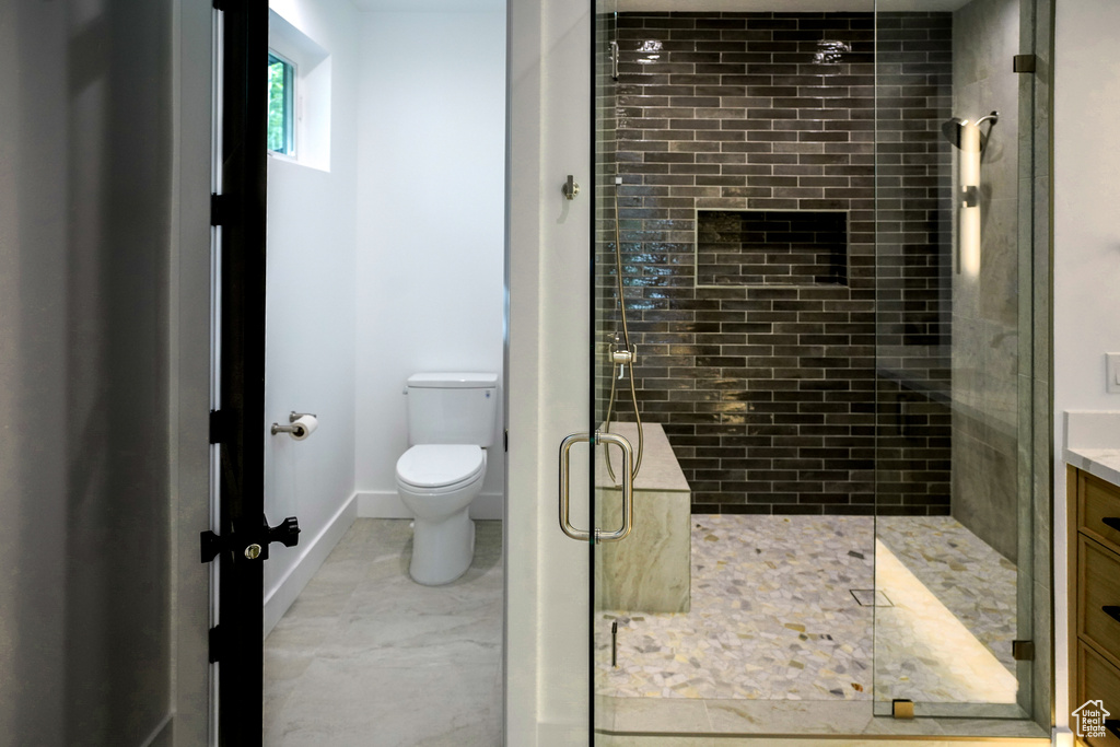 Bathroom featuring a stall shower and vanity