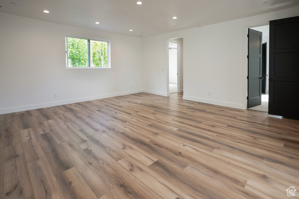 Spare room with light wood finished floors and recessed lighting