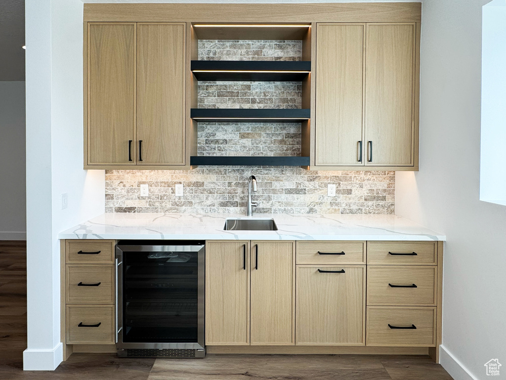 Indoor wet bar featuring wine cooler, dark wood-type flooring, and tasteful backsplash