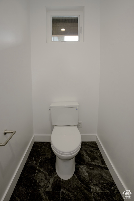 Bathroom with marble finish floors and baseboards