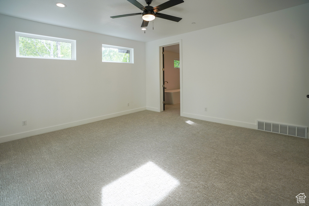 Unfurnished room with light colored carpet, ceiling fan, and recessed lighting