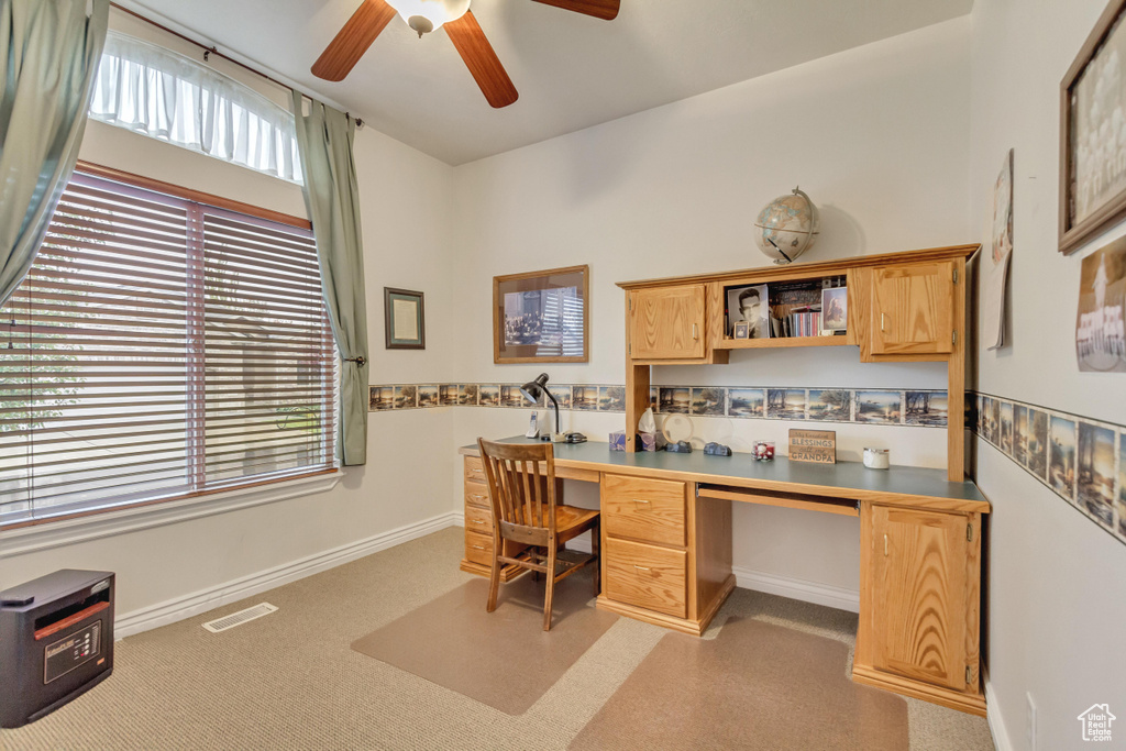 Office area with ceiling fan and built in desk