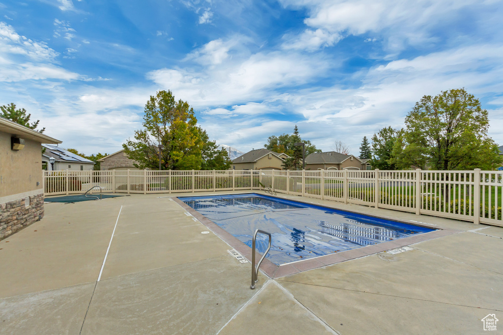 Community pool featuring a patio