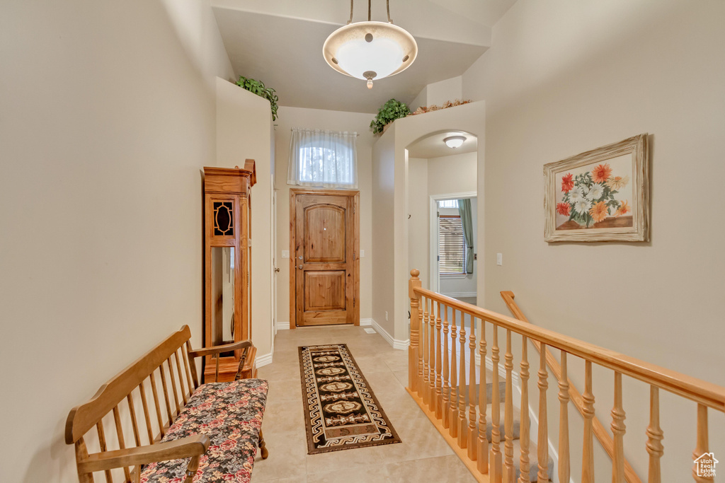 Entryway featuring light tile patterned flooring and arched walkways