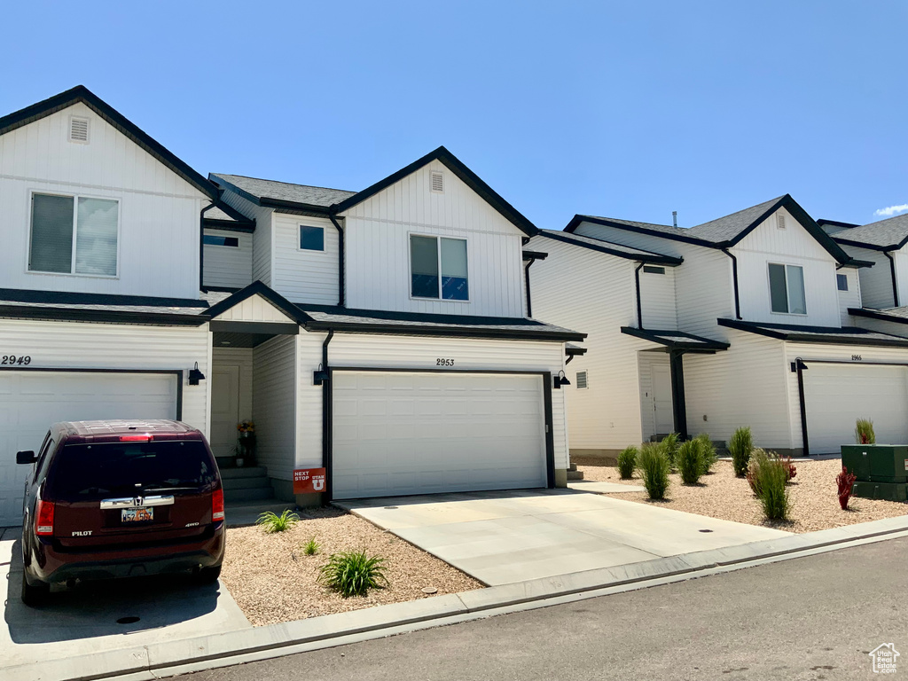 View of front of home with an attached garage and driveway