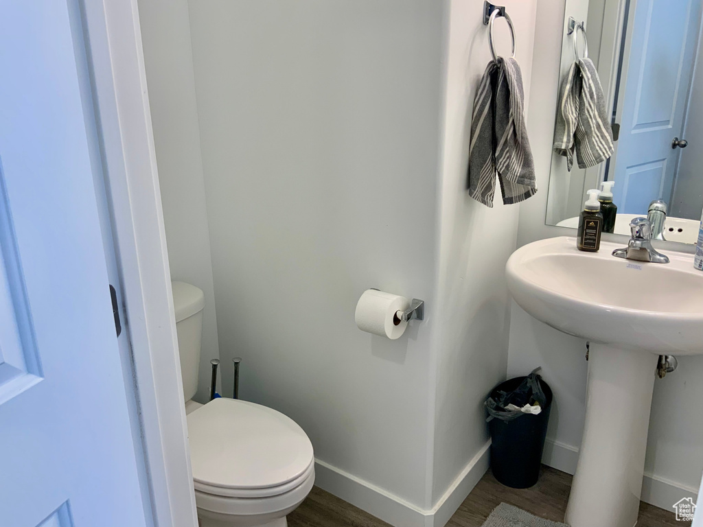 Bathroom with toilet and wood finished floors