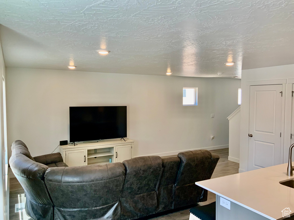Living room with baseboards and light wood-style flooring