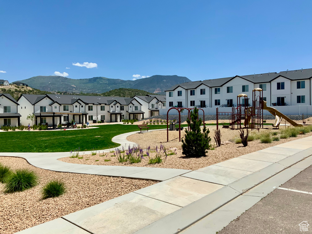 View of community with a residential view, a lawn, and a mountain view