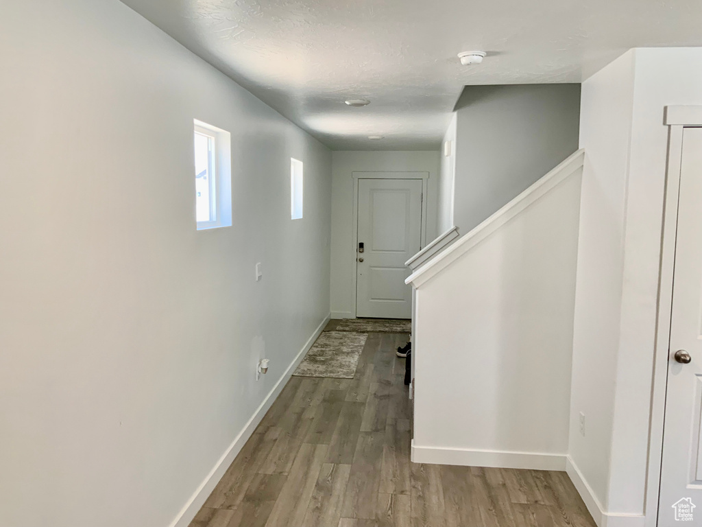 Corridor featuring wood finished floors and baseboards