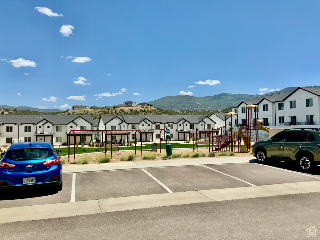Uncovered parking lot featuring a residential view and a mountain view