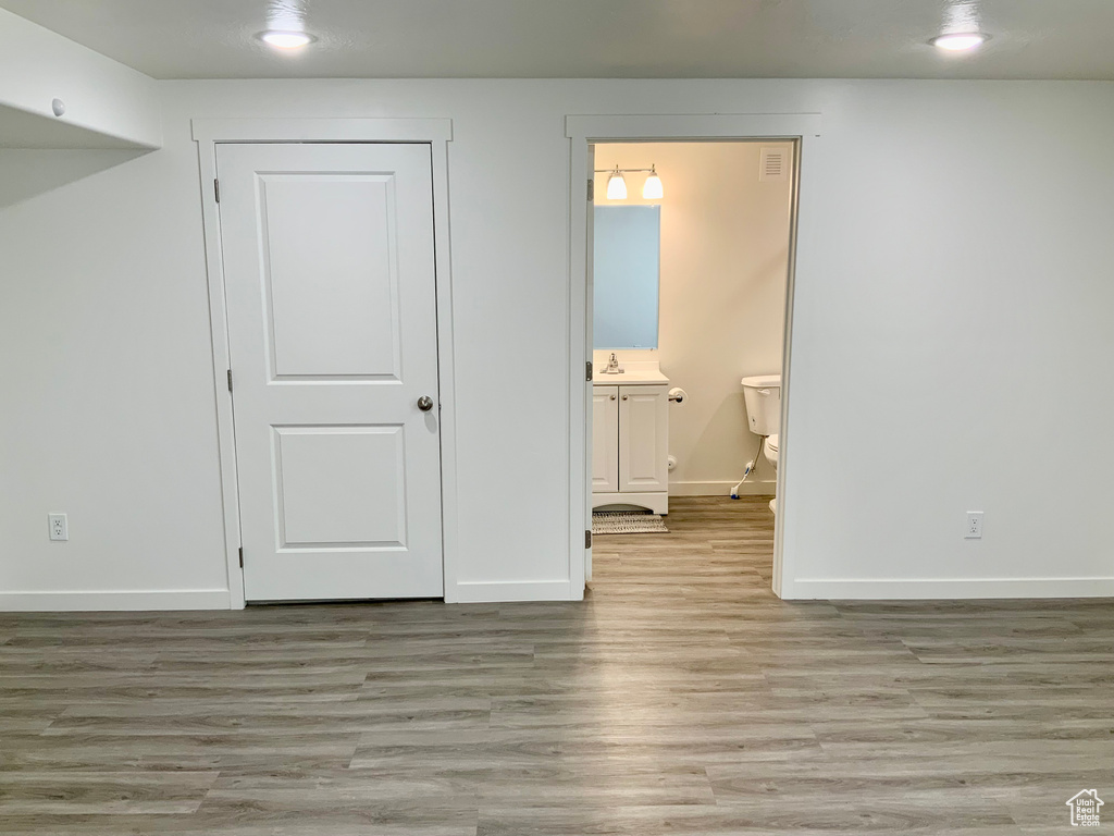 Unfurnished bedroom with light wood-style flooring, recessed lighting, and connected bathroom
