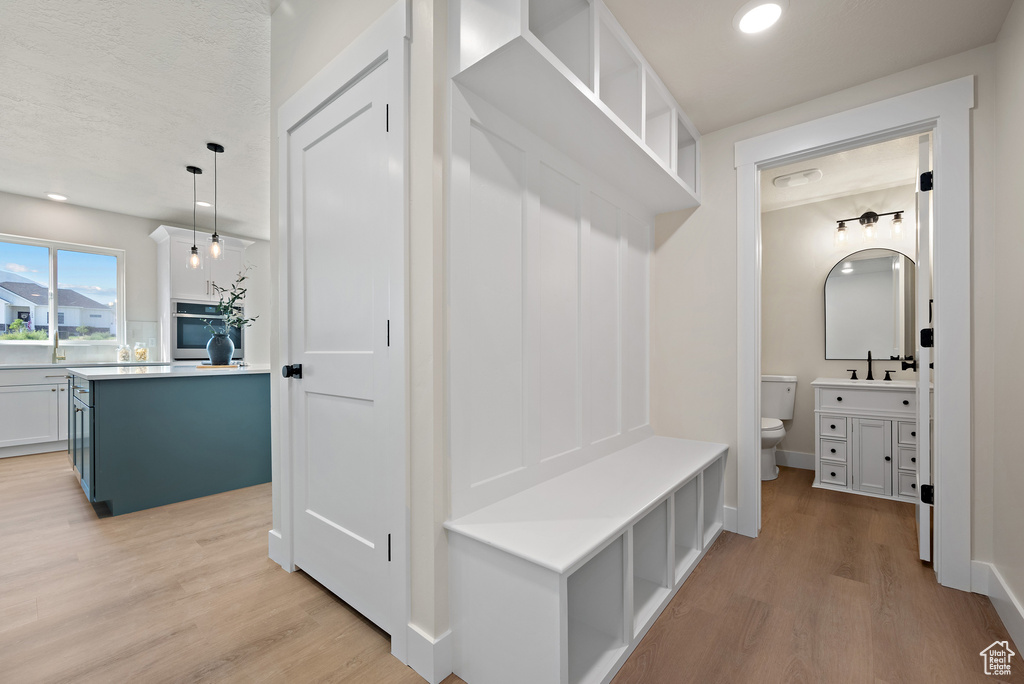 Mudroom featuring light wood finished floors and recessed lighting