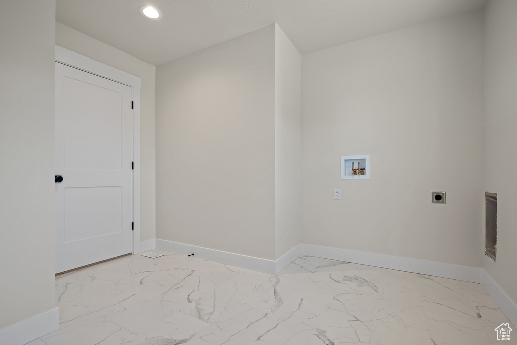 Washroom with electric dryer hookup, light marble finish floors, washer hookup, and recessed lighting