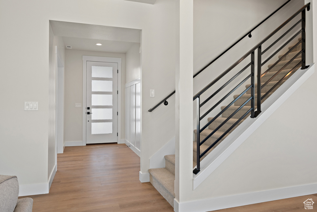 Entryway featuring light wood-type flooring, stairway, and recessed lighting