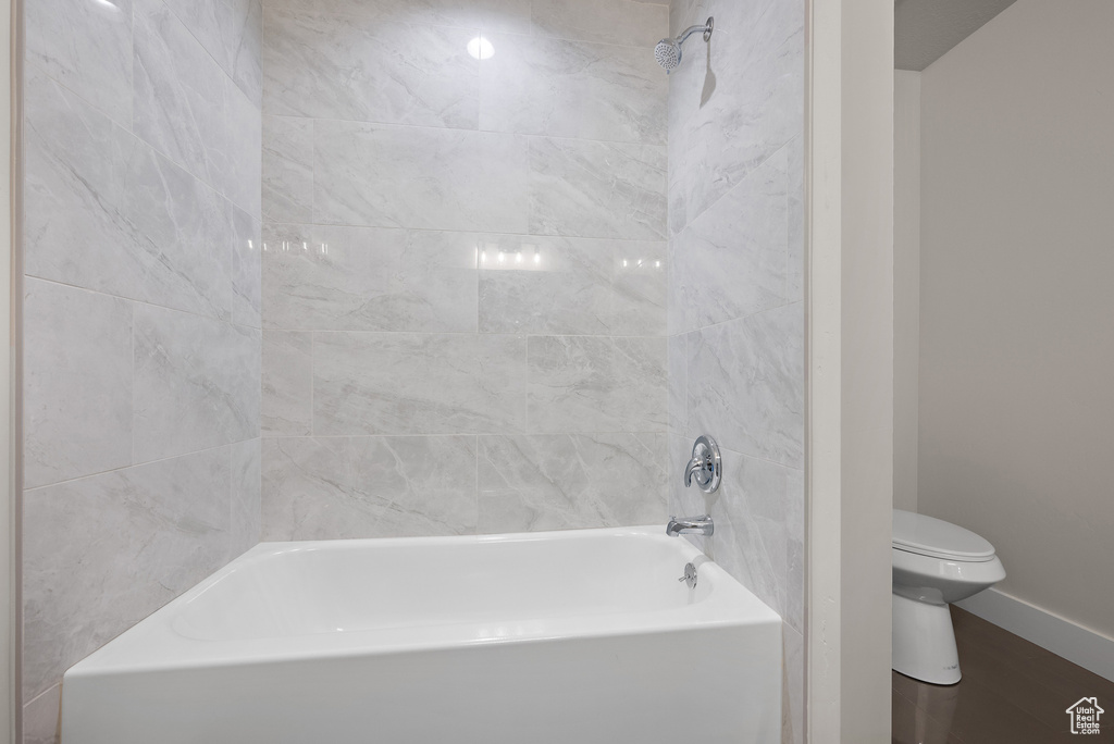 Bathroom with  shower combination and wood finished floors