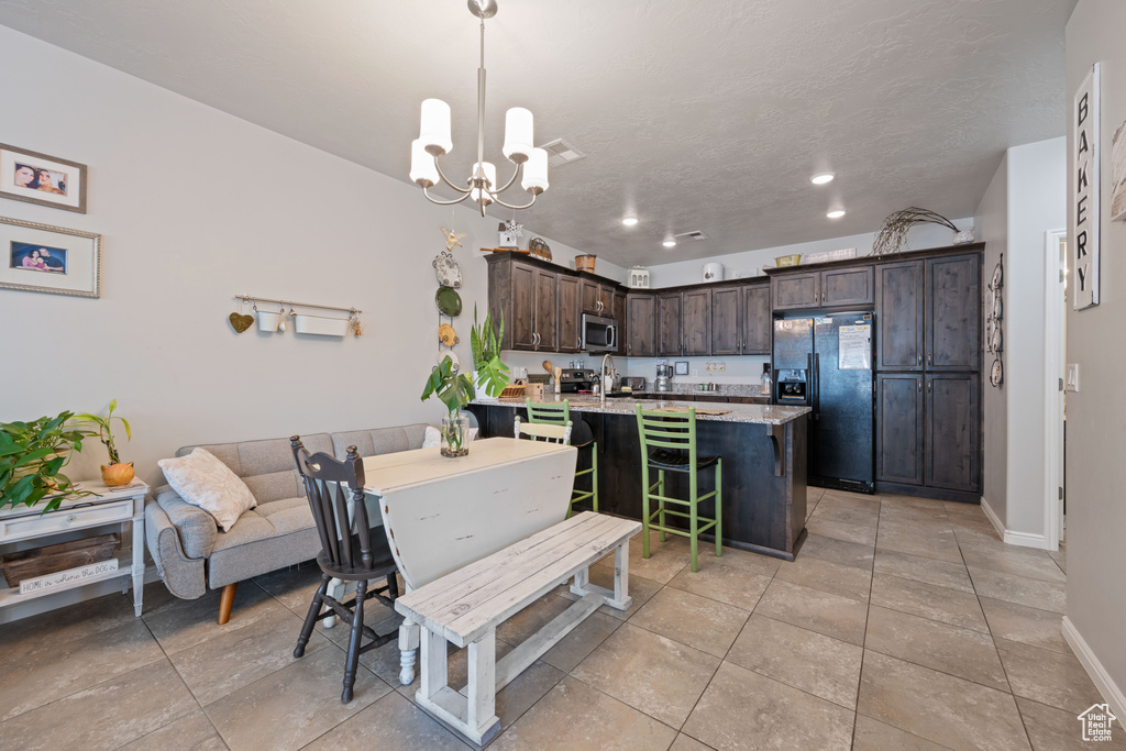 Dining area with a chandelier, recessed lighting, and light tile patterned flooring