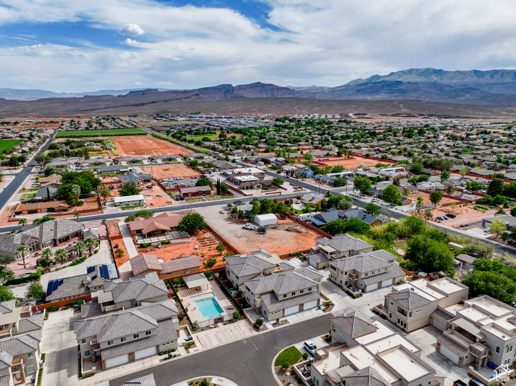 Aerial view of residential area featuring a mountainous background