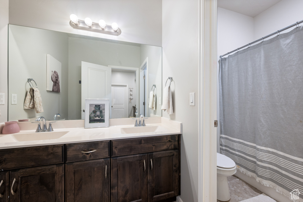 Full bath featuring double vanity and curtained shower