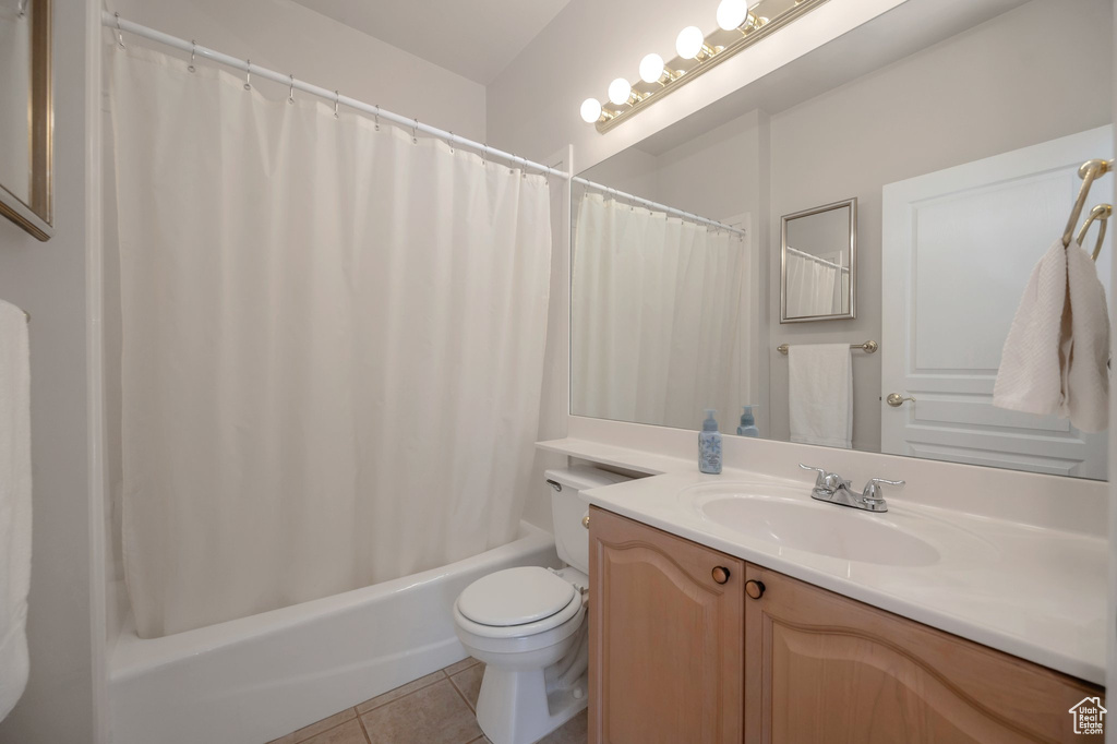 Bathroom featuring vanity, tile patterned flooring, and shower / bath combo