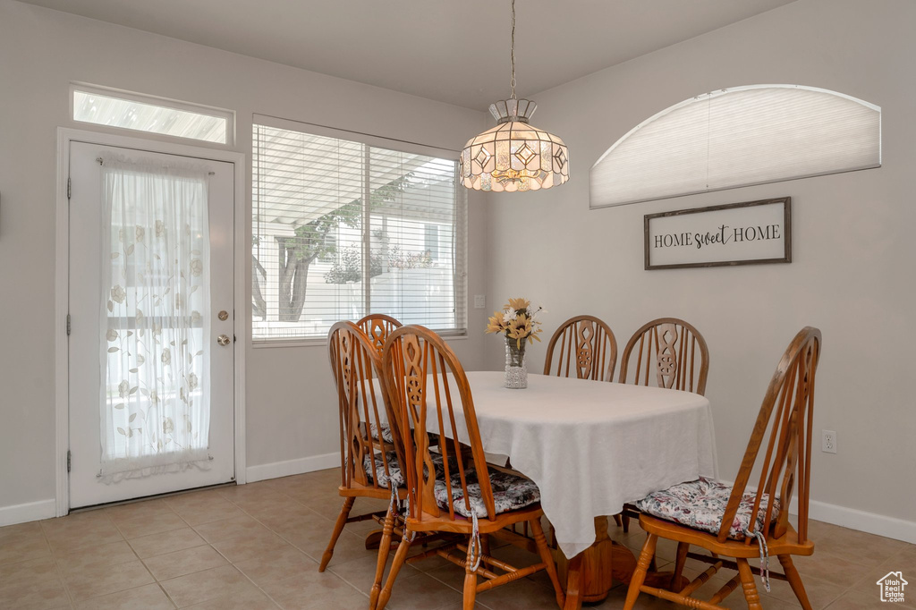 Dining area with light tile patterned floors and baseboards