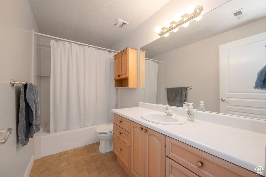 Bathroom featuring vanity and shower / bath combo with shower curtain
