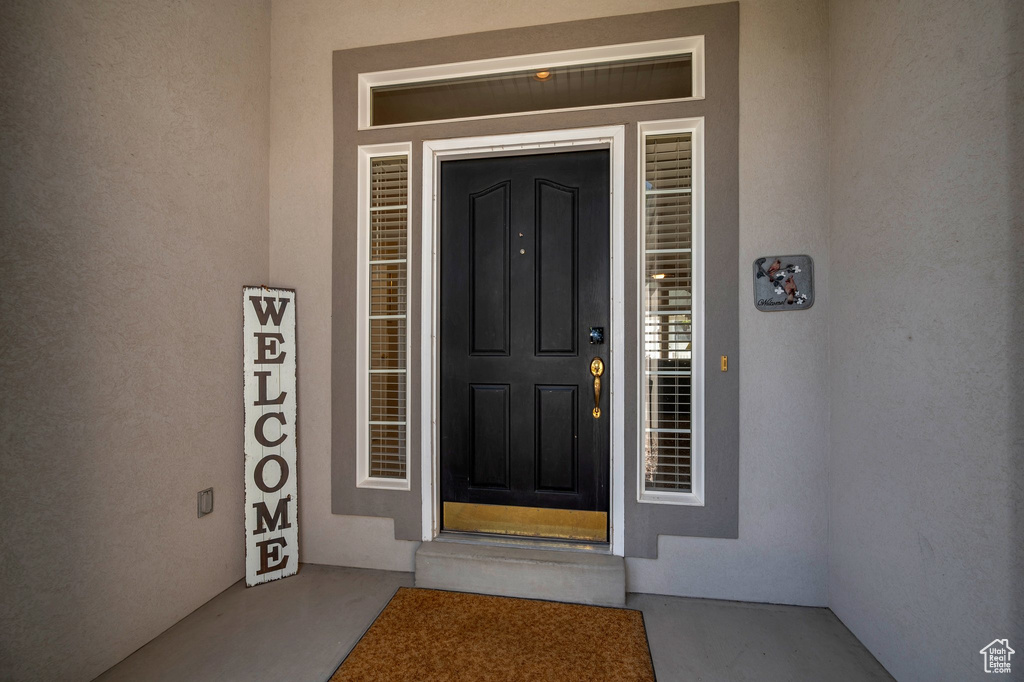 Entrance to property featuring stucco siding