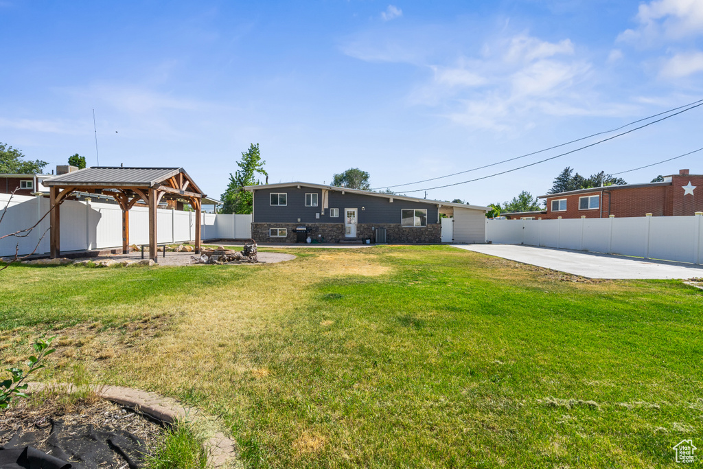Fenced backyard with a gazebo and a patio area