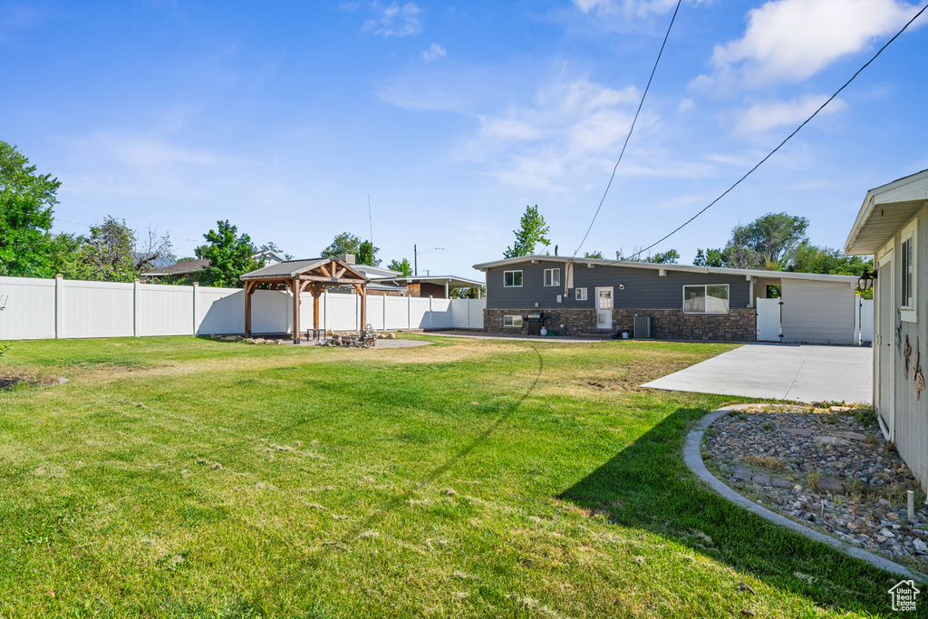 Fenced backyard with a gazebo and a patio area