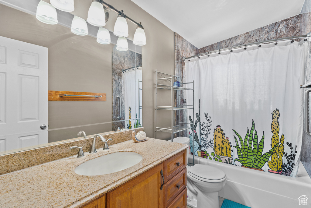 Bathroom featuring vanity and shower / tub combo with curtain