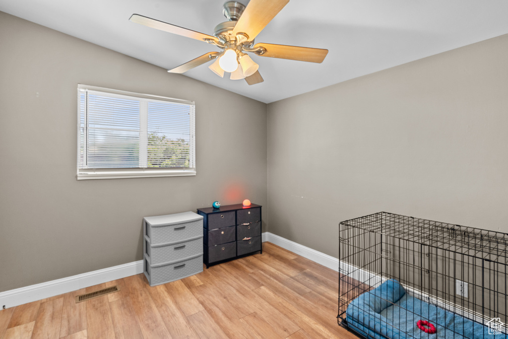 Bedroom with light wood-type flooring and a ceiling fan