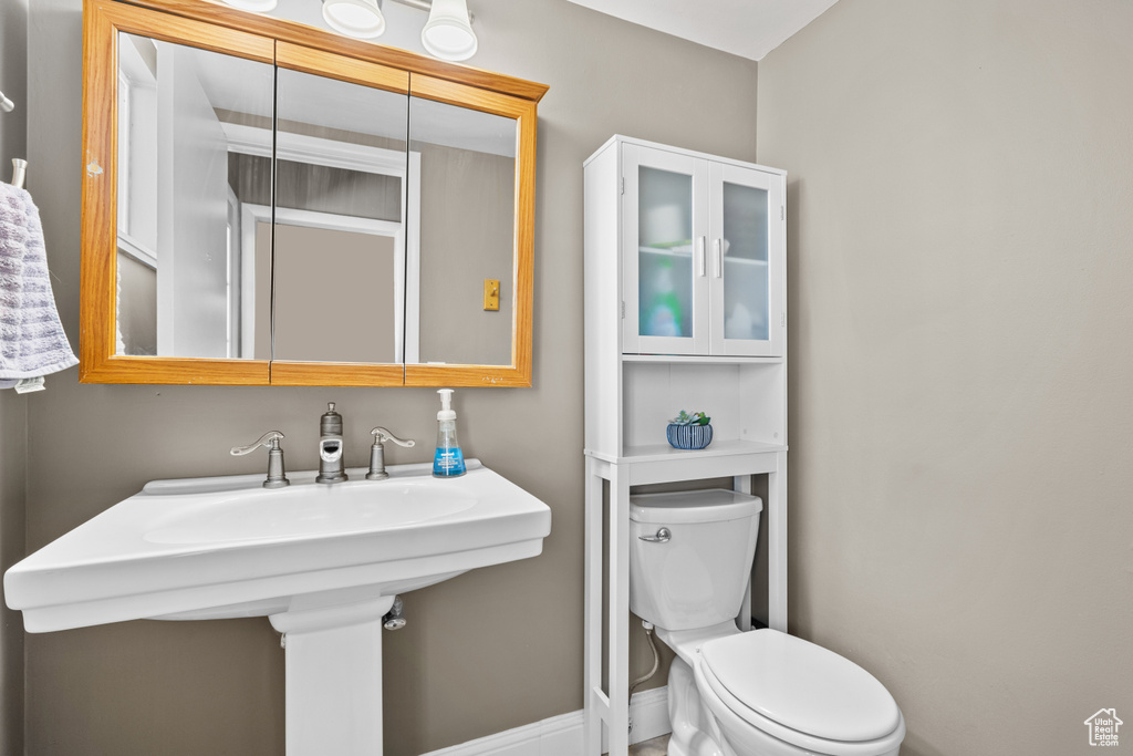Half bathroom featuring toilet and a sink