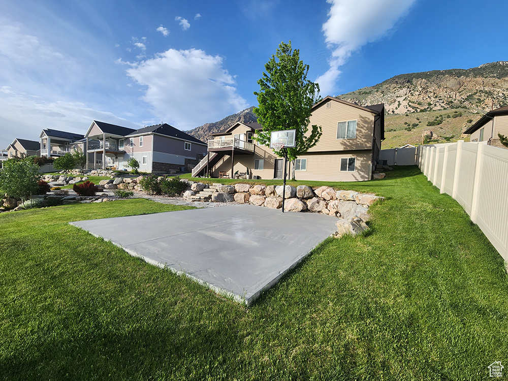 View of yard featuring a residential view, basketball court, and a mountain view