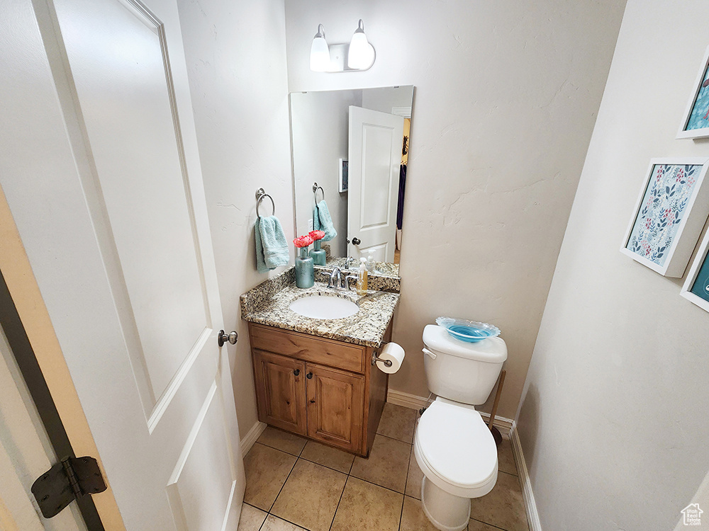 Half bath featuring vanity and tile patterned floors