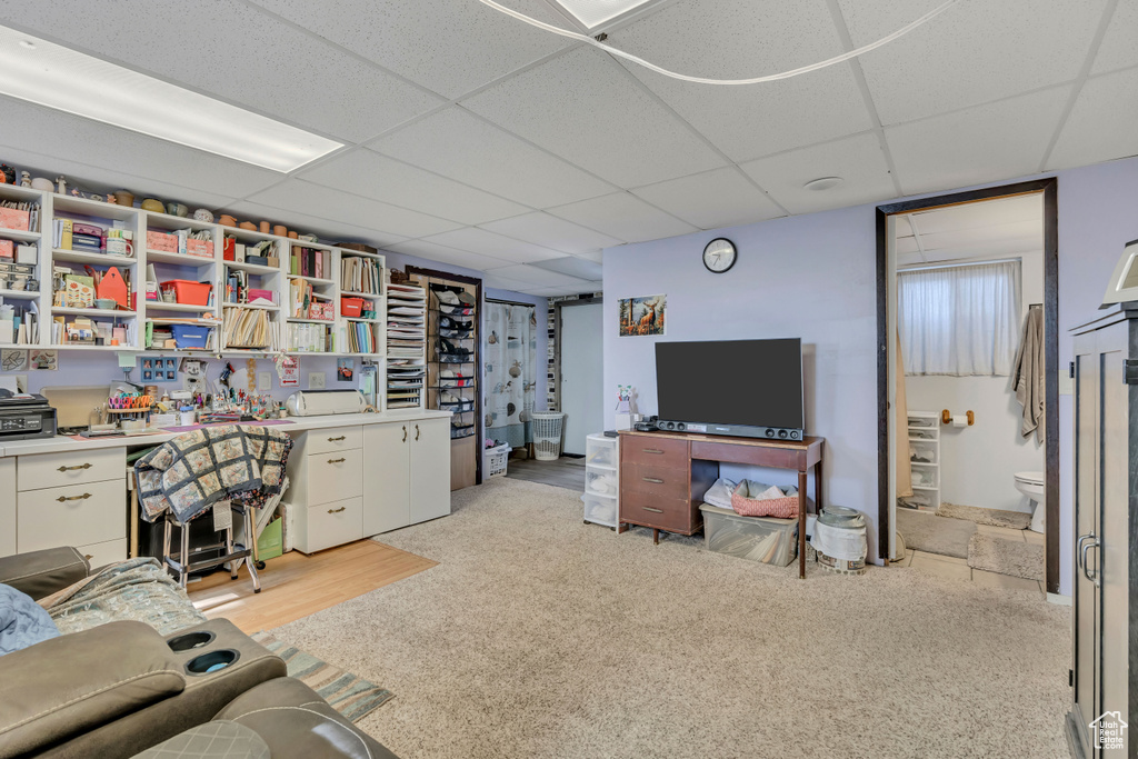 Home office featuring a paneled ceiling and light carpet