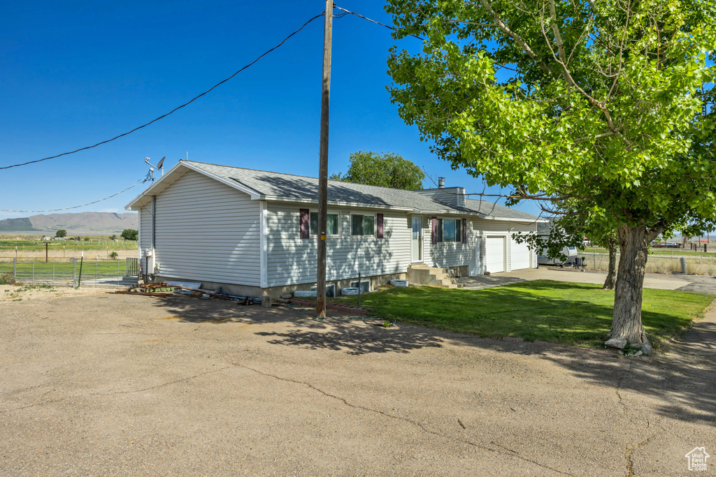 Single story home featuring a garage and concrete driveway