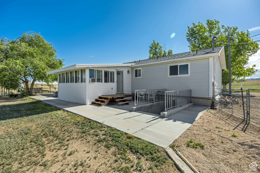 Rear view of house featuring a patio