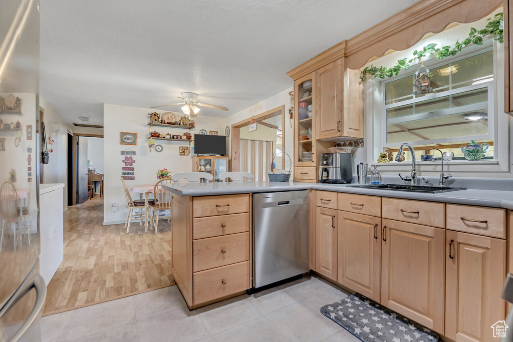 Kitchen featuring dishwasher, light brown cabinetry, a peninsula, ceiling fan, and light countertops