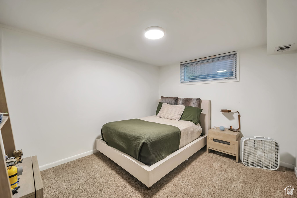 Carpeted bedroom featuring baseboards