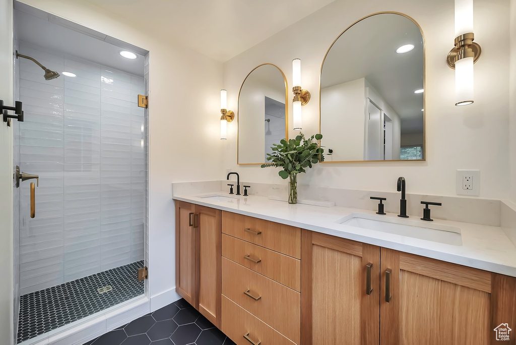 Bathroom with a stall shower, double vanity, tile patterned flooring, and recessed lighting