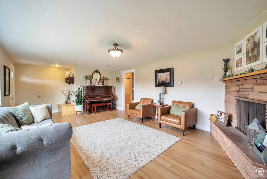 Living area with light wood-type flooring and a fireplace