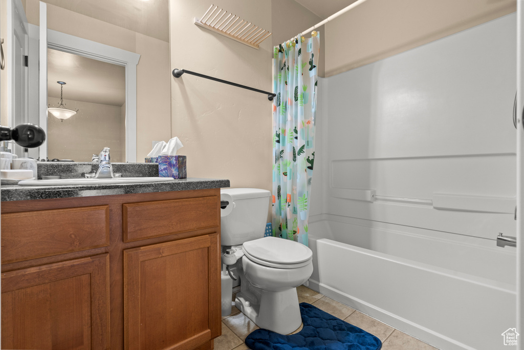Full bathroom with vanity, tile patterned flooring, and shower / tub combo with curtain